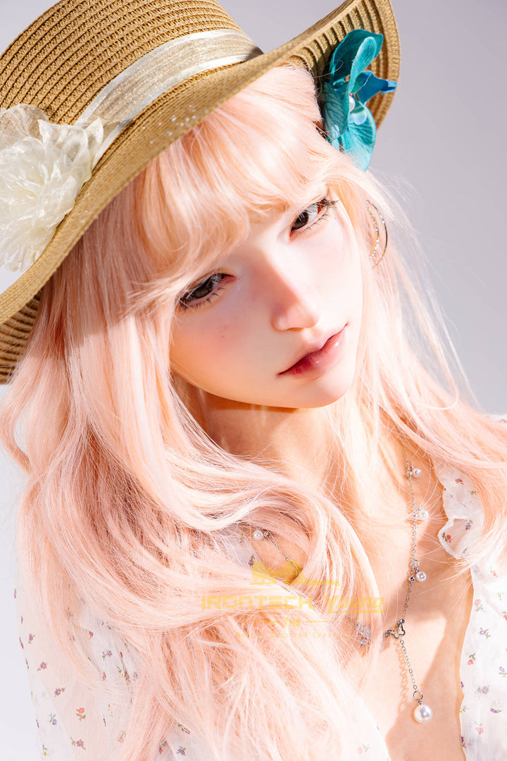 Irontech Doll 166 cm 2.0 Young Series E Silicone - Mio seated close-up in the straw sun hat, white floral top, and denim shorts