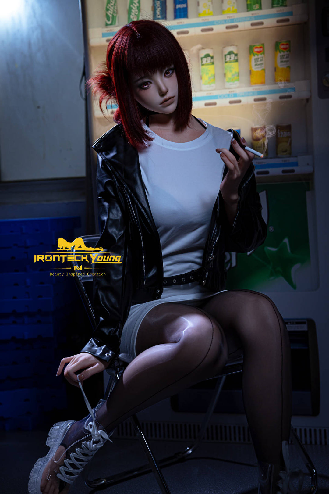 Irontech Doll 171 cm D Young Series Silicone - Ria – seated on a crate in a leather jacket and black tights