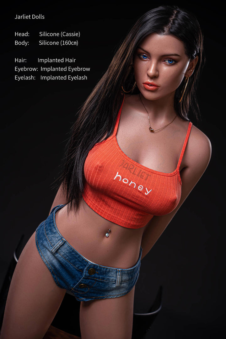 Jarliet Doll 160 cm C Silicone - Cassie standing pose in the orange bralette top and denim shorts at a different angle, dark backdrop