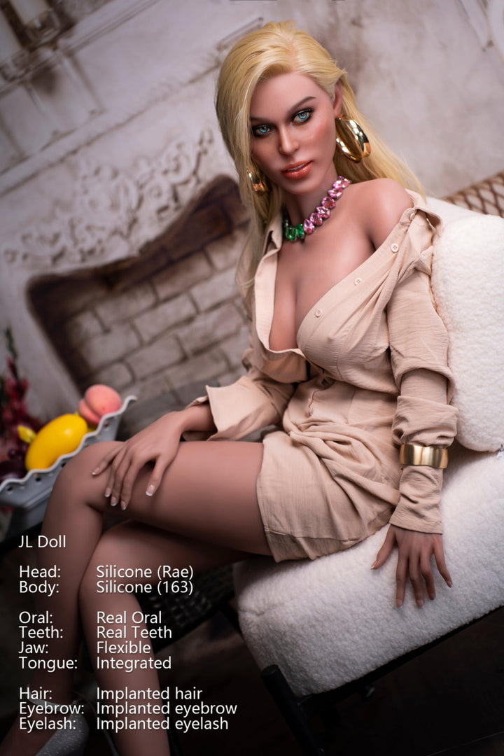 Full-length shot of the Rae doll sitting on a white armchair with legs crossed, highlighting its 163 cm height.