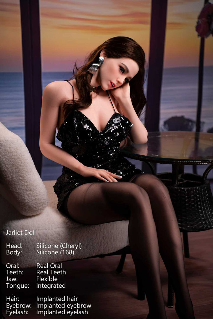 Jarliet Doll 168 cm D Silicone - Cheryl wearing a sexy black sequin dress seated on cream sofa, glass table and sunset visible at the background.