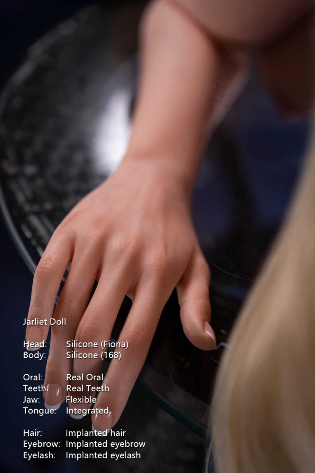 Jarliet Doll 168 cm D Silicone - Fiona close-up capture of hand resting on glass table, blue background.