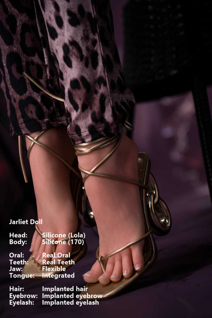 Jarliet Doll 170 cm G Silicone - Lola wearing a leopard print pants with gold strappy heels, close-up detail of feet, dark violet background.