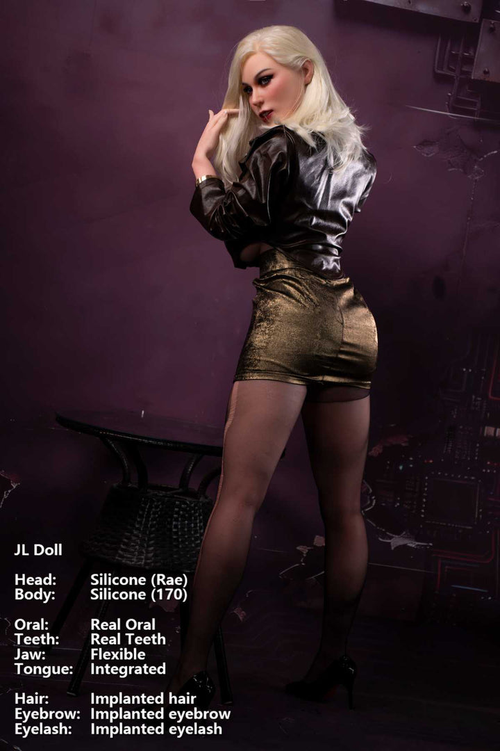 Jarliet Doll 170 cm G Silicone - Rae wearing a black leather jacket paired with gold shorts and net stockings with heels, standing rear three-quarter pose against a dark violet background.