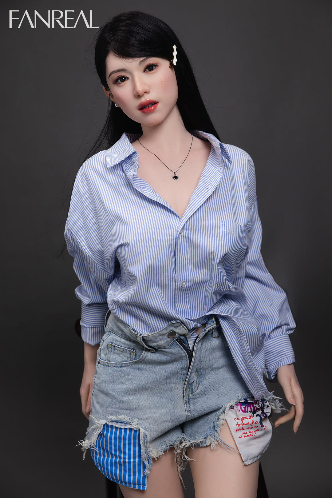 Fanreal 155cm silicone doll Kimmy wearing blue shirt sitting on bed
