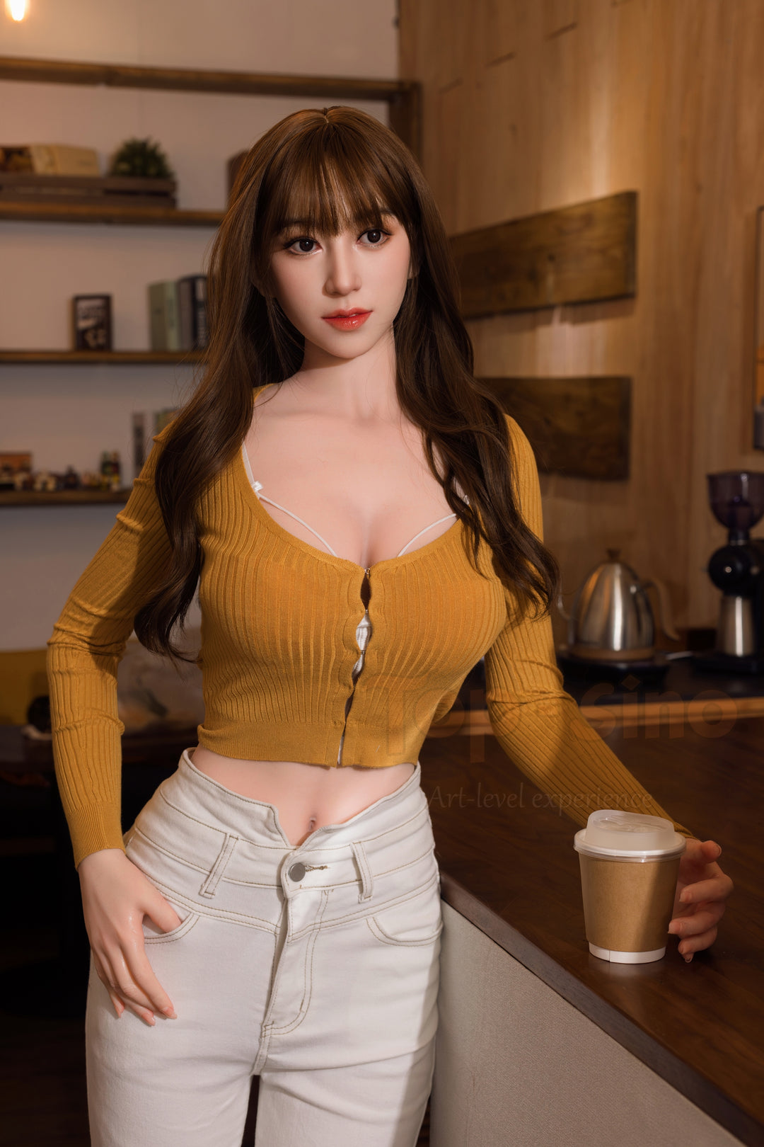 Top Sino 169 cm Platinum Silicone - Nanatsumori Riri (RRS+) in a yellow top and white pants holding a coffee cup in a kitchen.