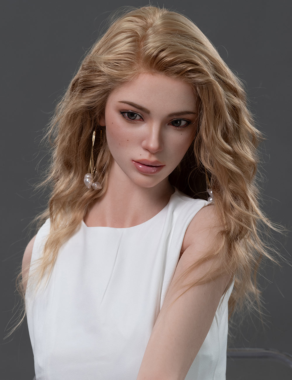Close-up of Maggie sex doll with wavy blonde hair in white dress