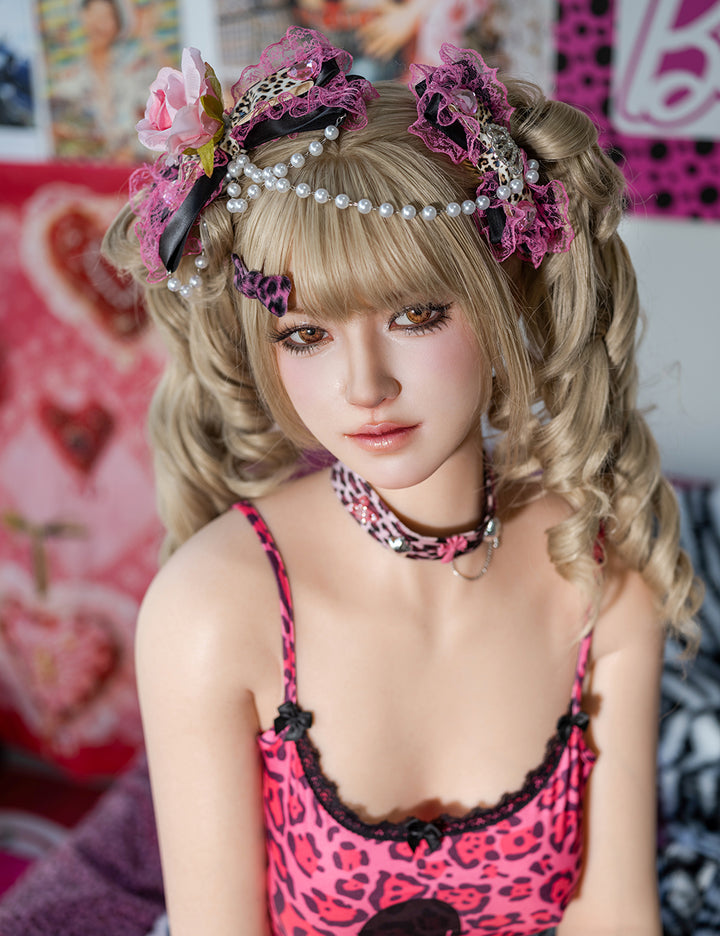 Portrait of the TOP-CYDOLL 162 cm E-Cup Mai Realistic Sex Doll wearing a pink animal print camisole and ornate hair bows.
