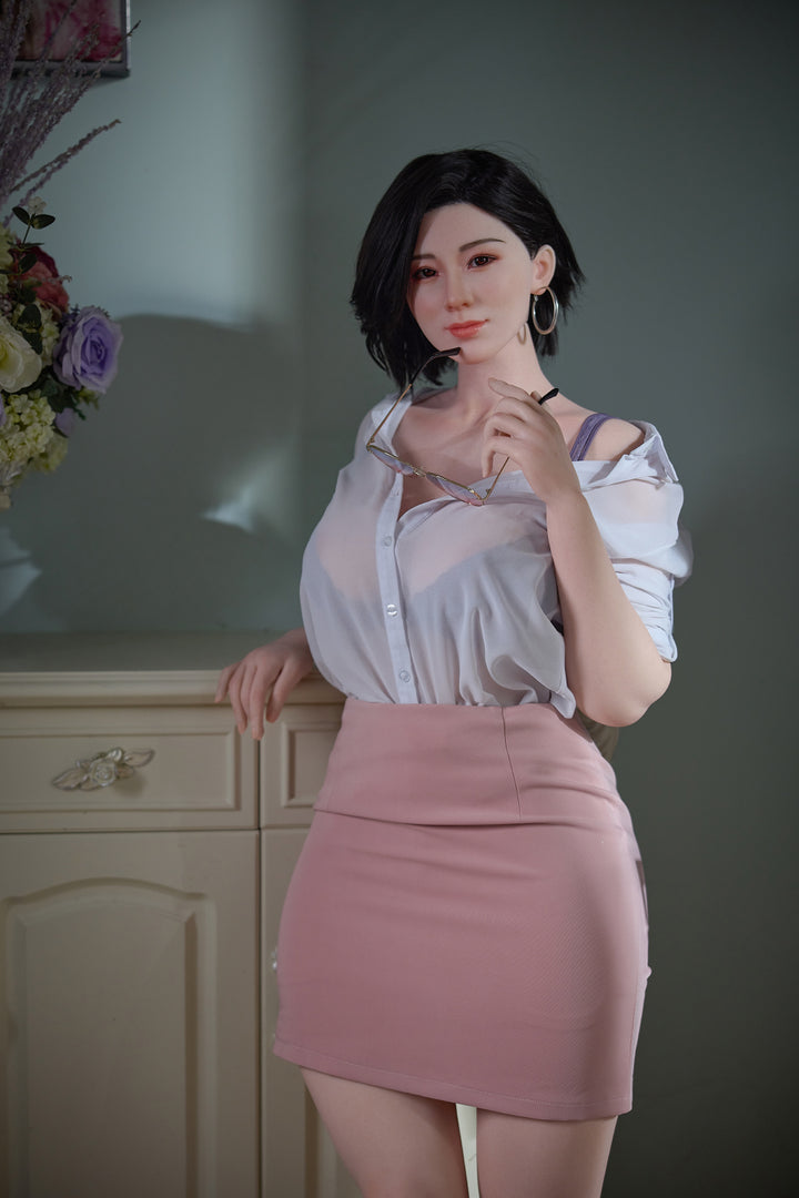 Starpery Hao doll dressed in a white blouse and pink skirt holding eyeglasses, posing indoors with lifelike details.