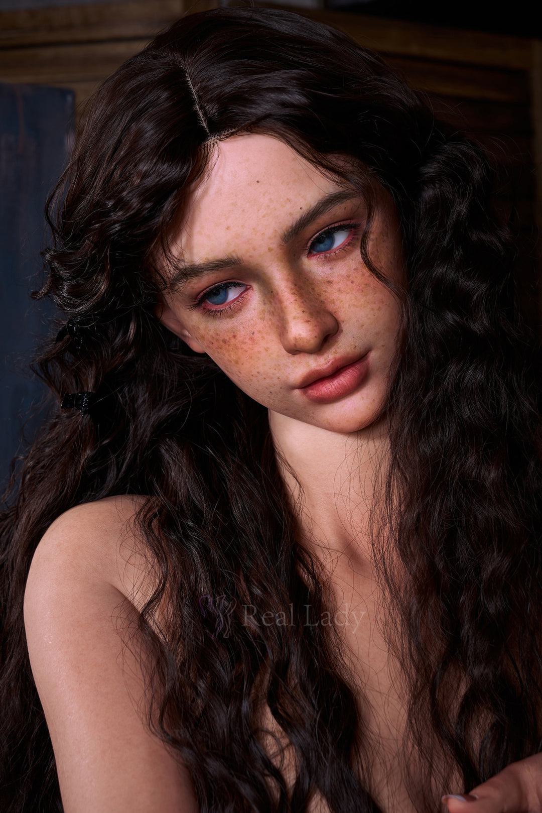 RealLady 159 CM H Silicone - Lena V4 upper body three-quarter view in white crochet headscarf and light outfit, highlighting realistic silicone skin texture with long dark wavy hair in rustic setting
