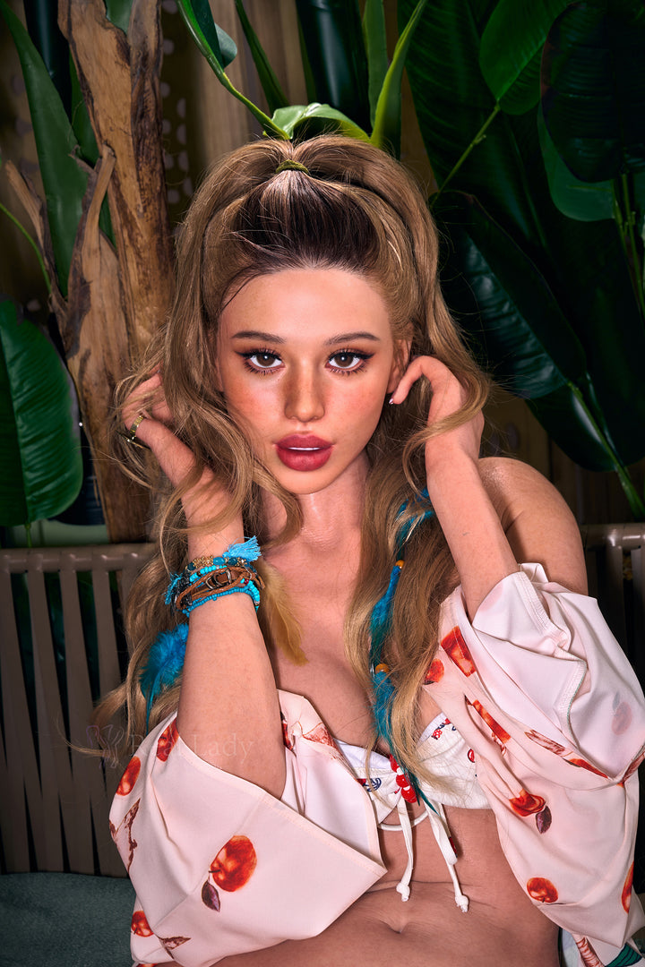 RealLady 170 cm C Silicone - Sienna with styled hair posing in a floral dress against a leafy background