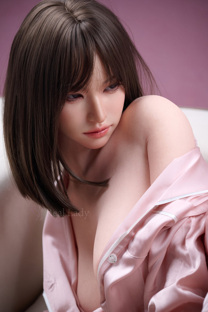 RealLady 150 cm E Pink Lover Series Silicone - Viki wearing a pink satin robe with a blurred background