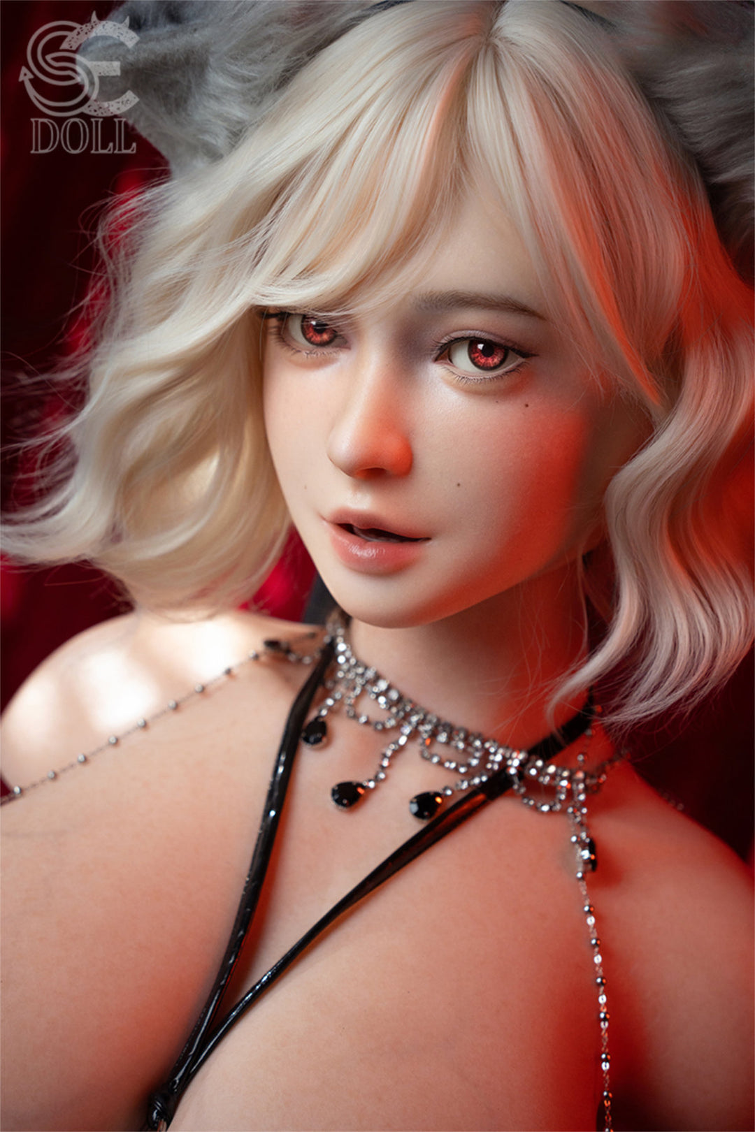 SEDOLL T110 cm J Silicone Torso - Maya.B close-up portrait, platinum blonde wavy hair, delicate layered necklace, bare shoulders, smoky red velvet backdrop