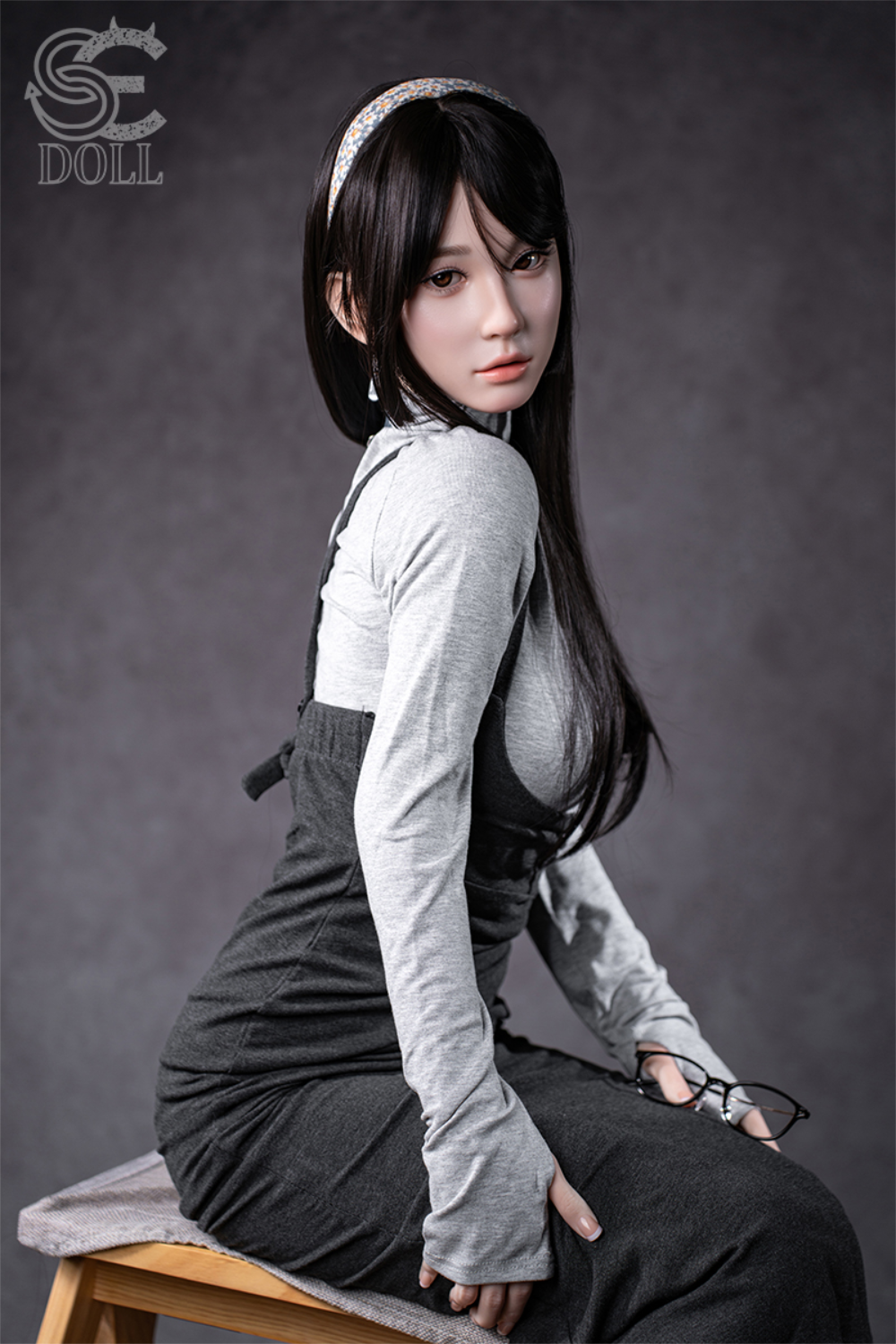SEDOLL T153 cm A Aya Series Silicone -  Hinata.A wearing a gray outfit with suspenders sitting on a bench.