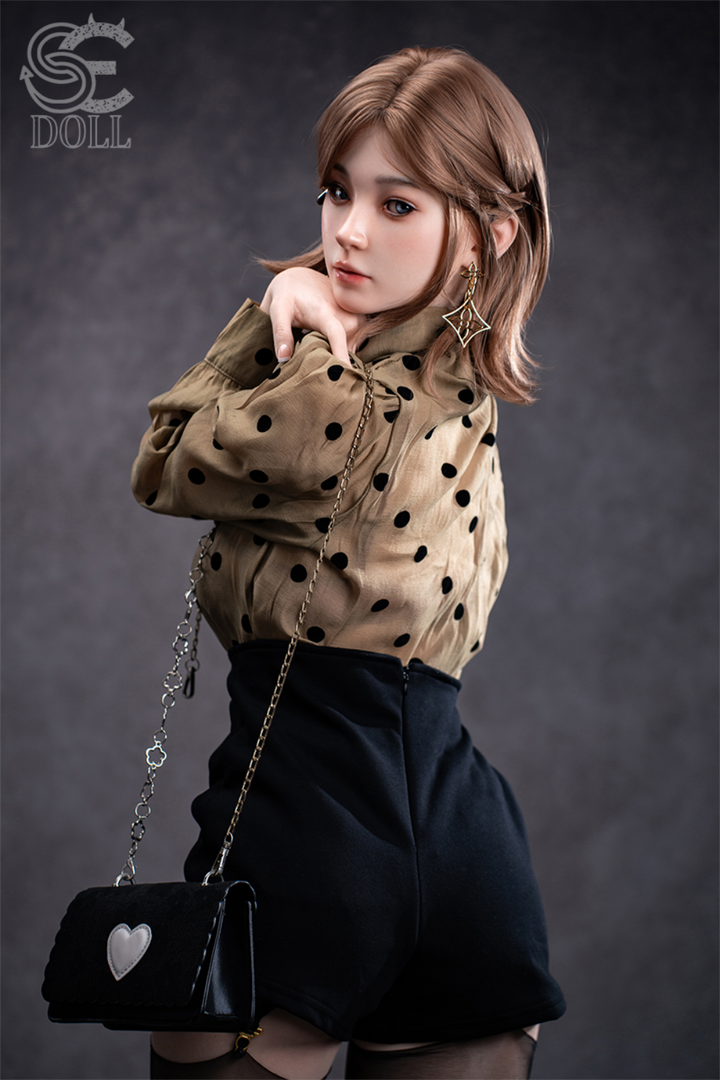 SEDOLL T153 cm A Aya Series Silicone -  Miori.C wearing a polka dot blouse and black skirt with a black handbag featuring a heart design.