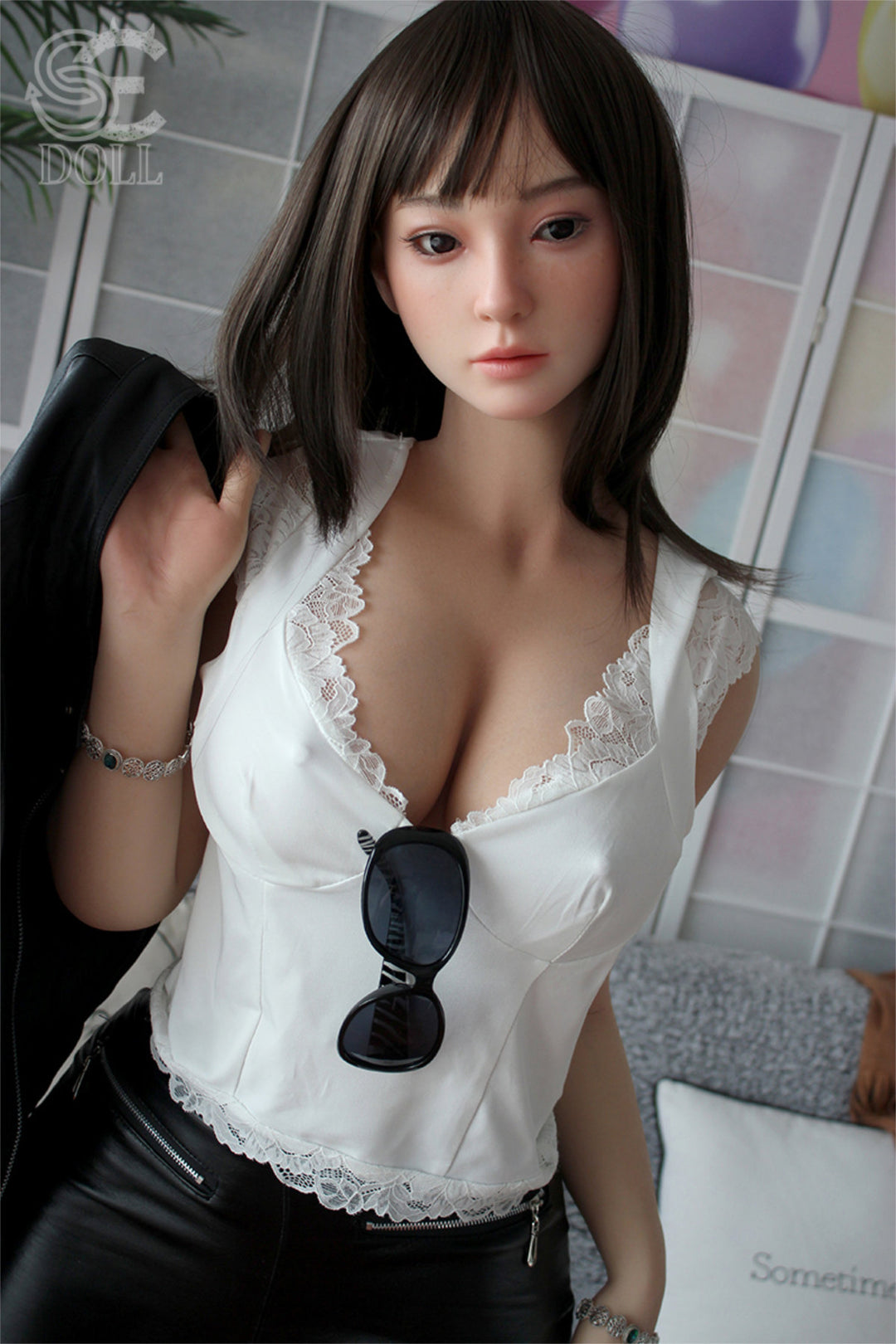 SEDOLL T161cm C Aya Series Silicone - Miori.C – Close-up pose holding a pair of sunglasses near the chest, white lace-trim top with sheer detailing, dark straight-bang hairstyle, softly lit neutral backdrop.