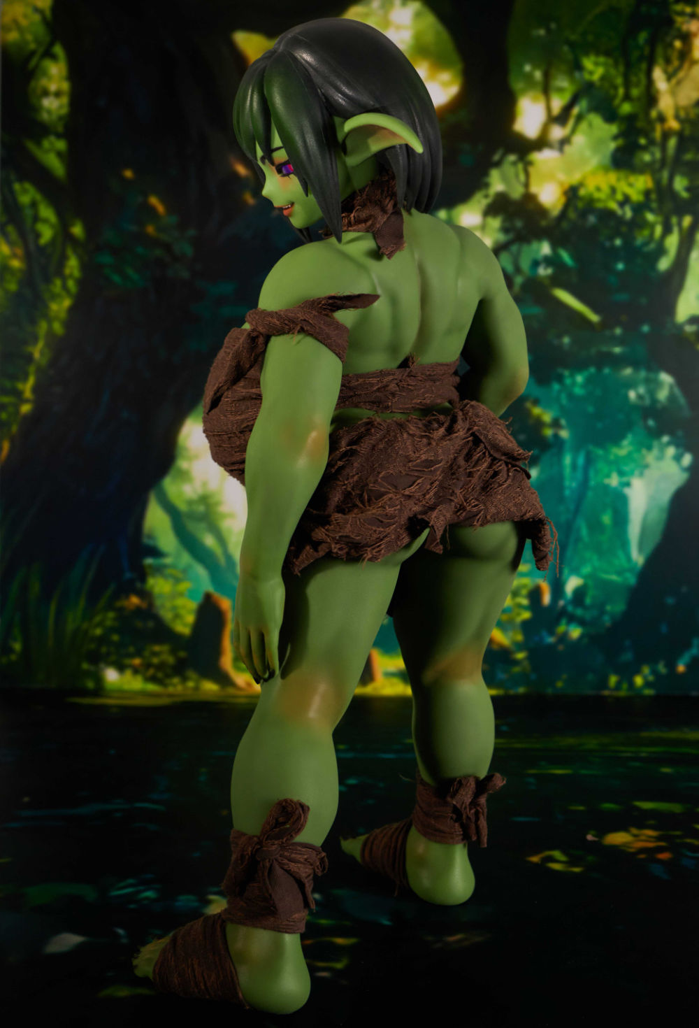 Green fantasy doll close-up face with short hair and pink eyeshadow