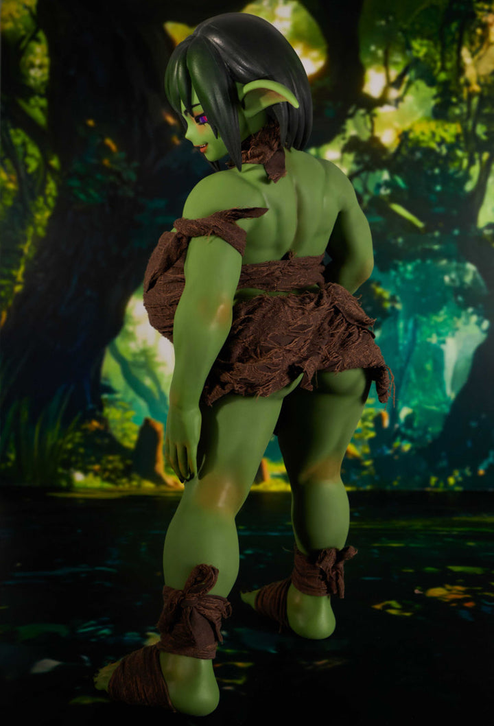 Green fantasy doll close-up face with short hair and pink eyeshadow