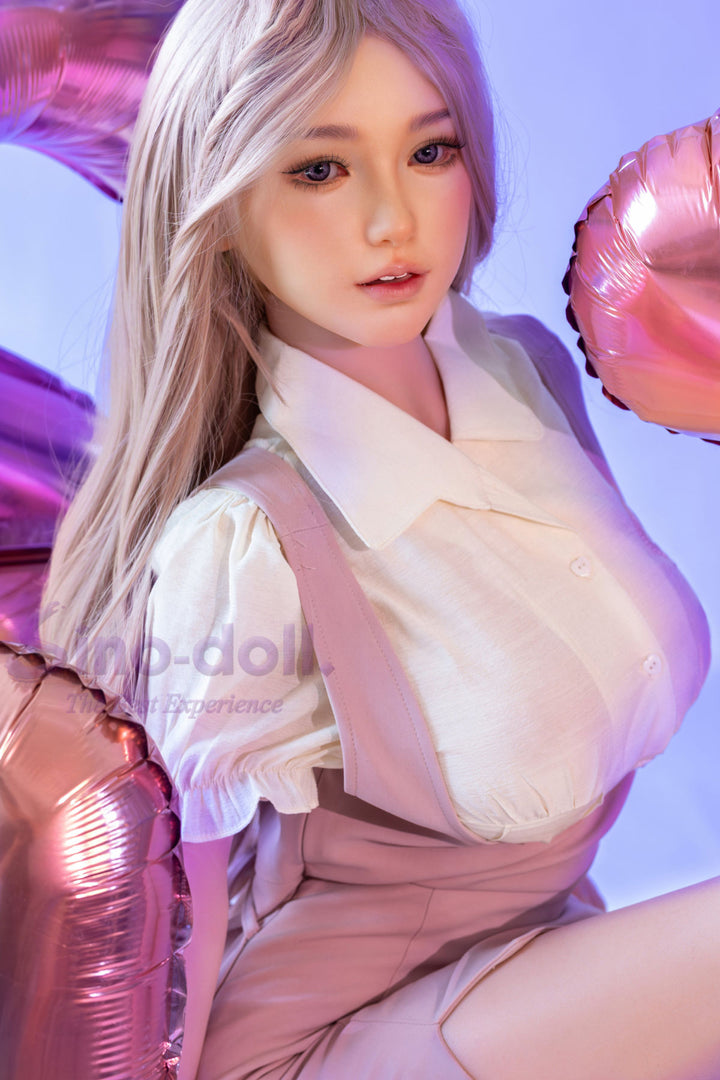 Sino Doll Pro Soft Max 161 cm Platinum Silicone - Linchun (R+S Effect) with blonde hair and a white outfit, surrounded by pink balloons.