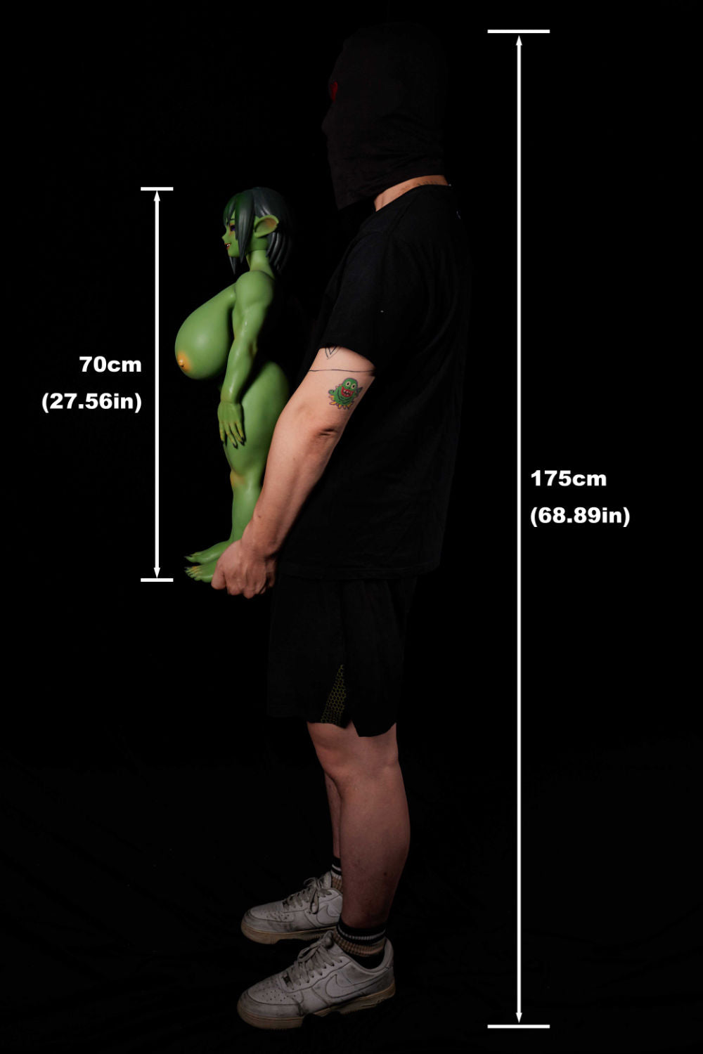 Side angle of green fantasy doll bust in forest