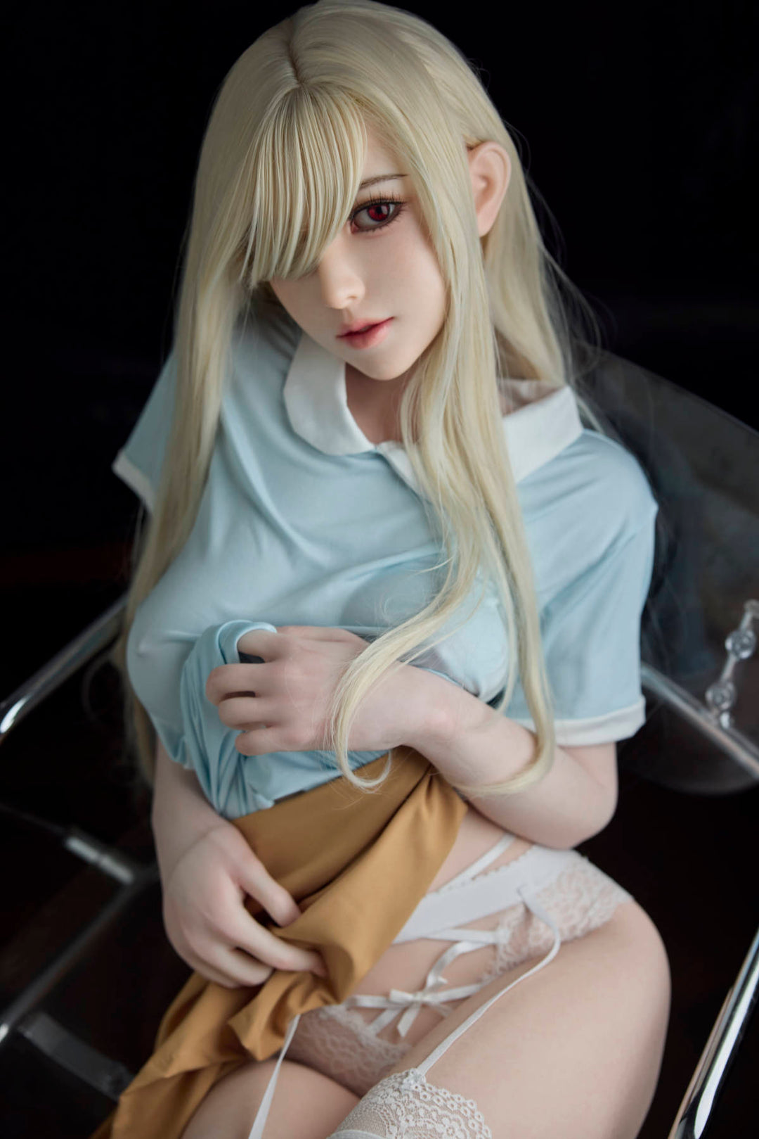 Starpery 151 cm B - Chuye – seated on a black chair in a blue dress and white thigh-high stockings