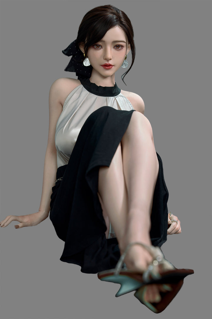Starpery 171cm D - Asuka Eva – Seated pose on chair, cream halter top with black skirt, dark hair in half-up style, plain grey backdrop.
