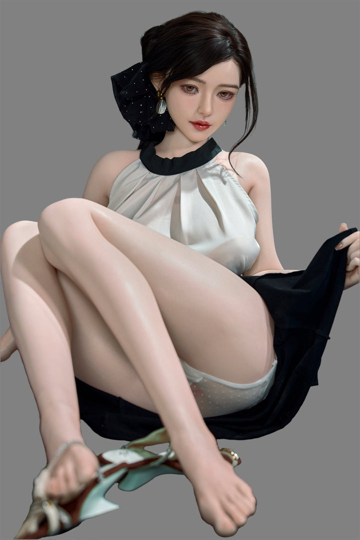 Starpery 171cm D - Asuka Eva – Seated pose on chair, cream halter top with black skirt, dark hair in half-up style, plain grey backdrop.