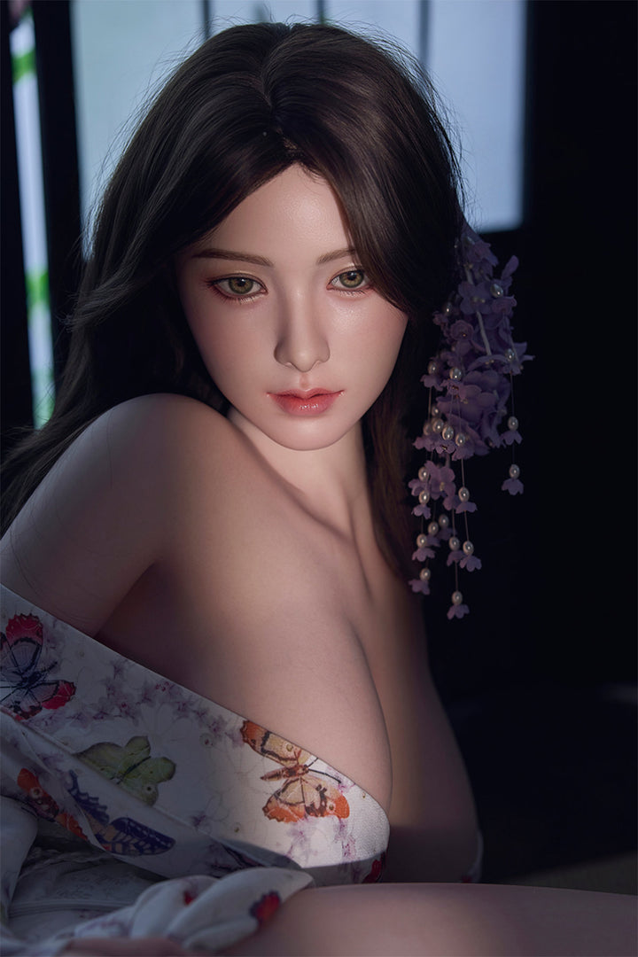 Starpery 171cm D - Xue V3 – Seated pose, floral kimono-style robe open at chest, dark wavy hair down, dark backdrop.