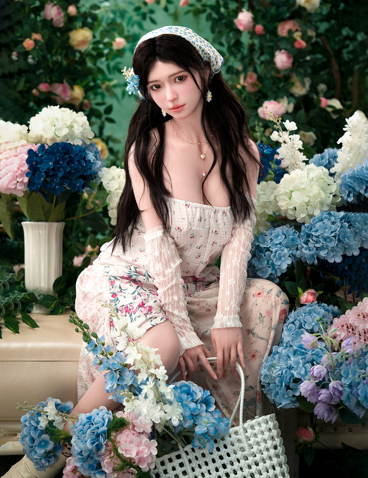 TOP-CYDOLL 167cm D-Cup Una Realistic Sex Doll in a floral dress sitting among flowers with a flowery background