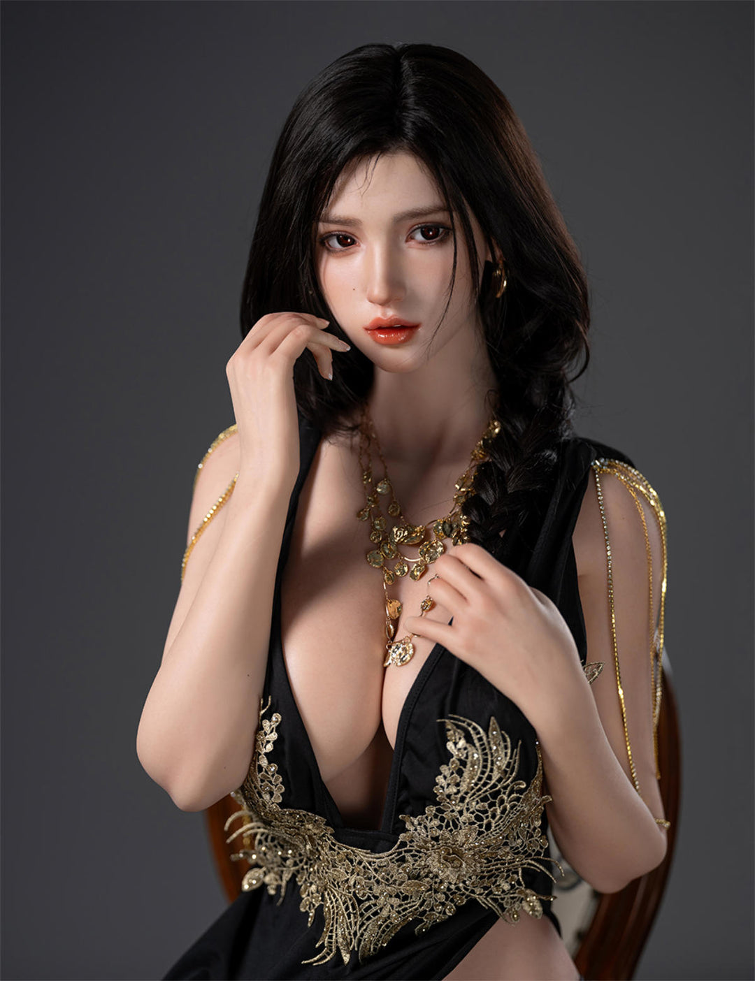 Close-up portrait of the TOP-CYDOLL 168cm F-Cup Lillian V2 Realistic Sex Doll with long dark hair, wearing a plunging black dress with intricate gold embroidery and a matching necklace.