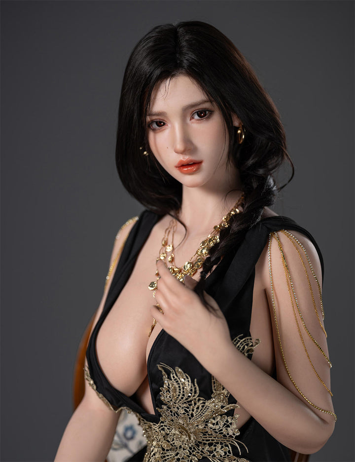 Angled close-up of the Lillian V2 doll, highlighting the deep V-neckline of the embroidered black dress and realistic facial features.