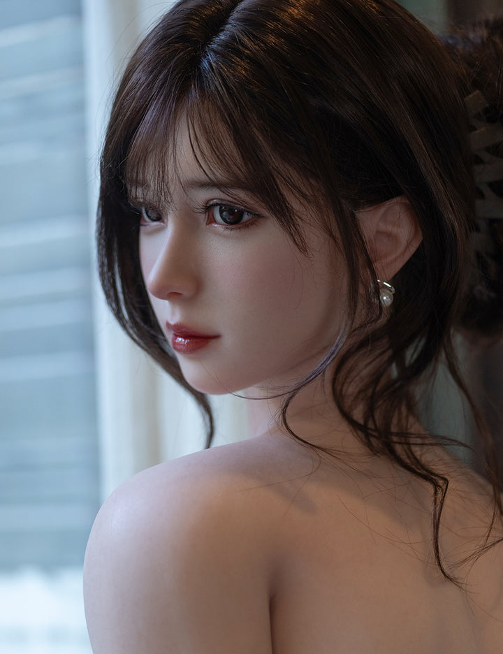 Side view of Una sex doll with long brown hair looking over shoulder