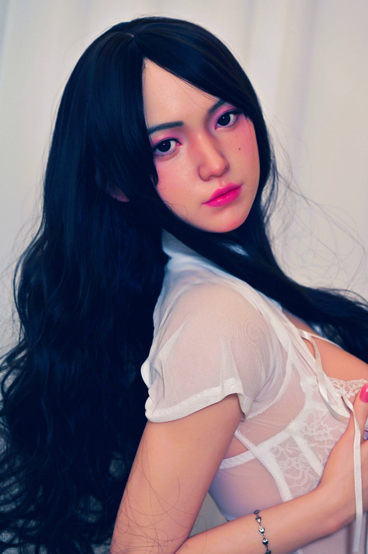 Zelex Doll K-Series 159 cm D Silicone - Suyeon upper body side view in white lace lingerie, long black wavy hair, bright indoor background
