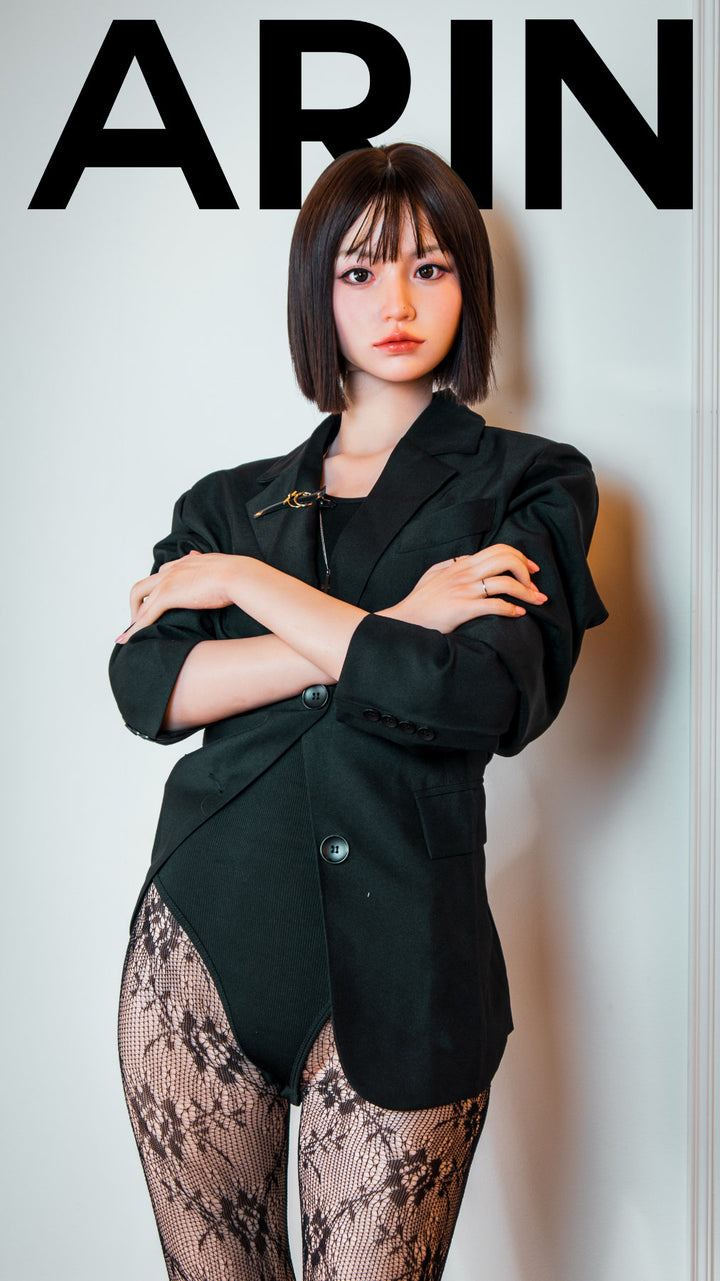 Zelex Doll K-Series 168 cm B Silicone - Arin full body standing pose in black oversized blazer with lace patterned stockings and crossed arms, short dark bob hair, white studio background
