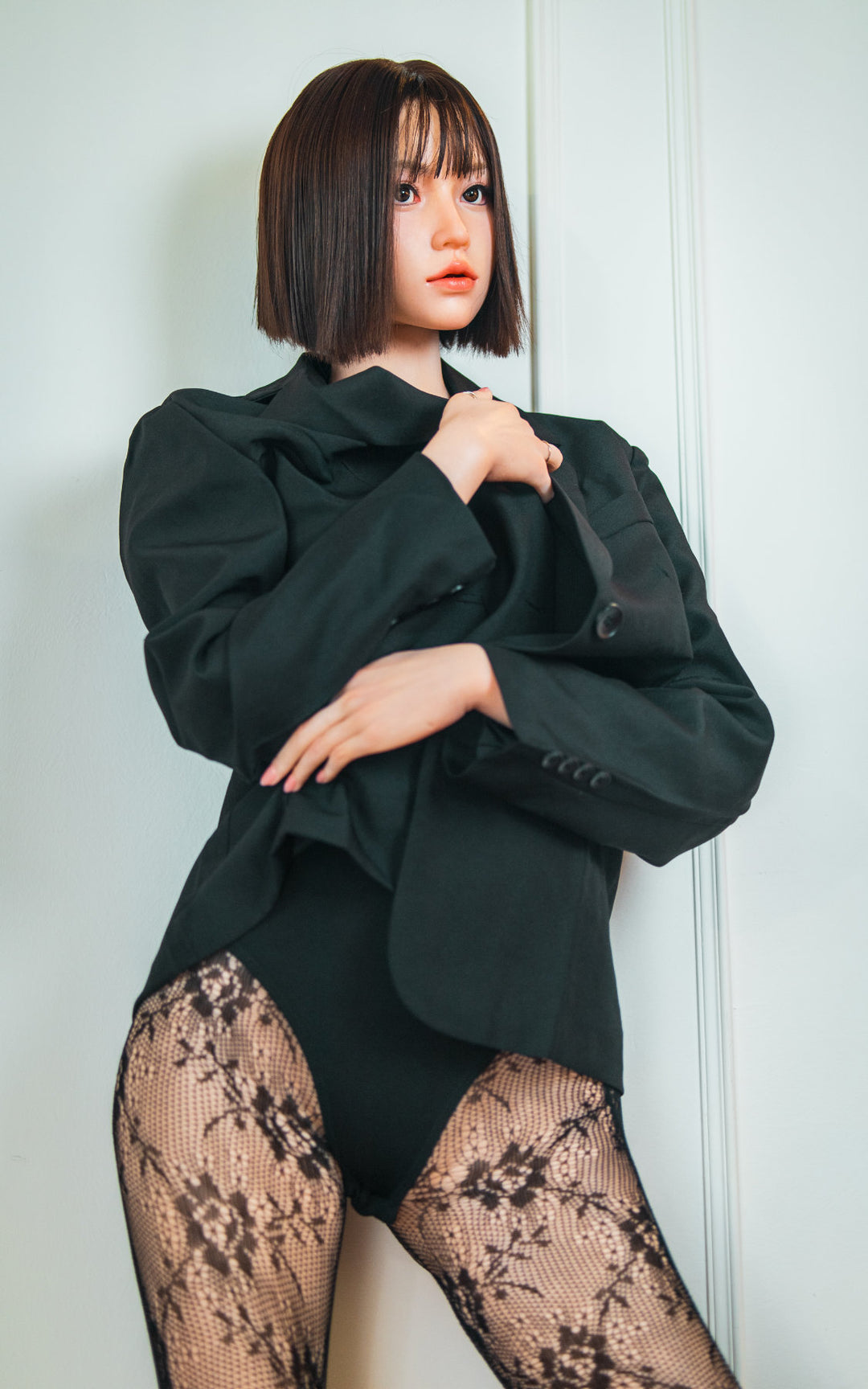 Zelex Doll K-Series 168 cm B Silicone - Arin full body rear view in black oversized blazer and lace patterned stockings, short dark bob hair, white studio background
