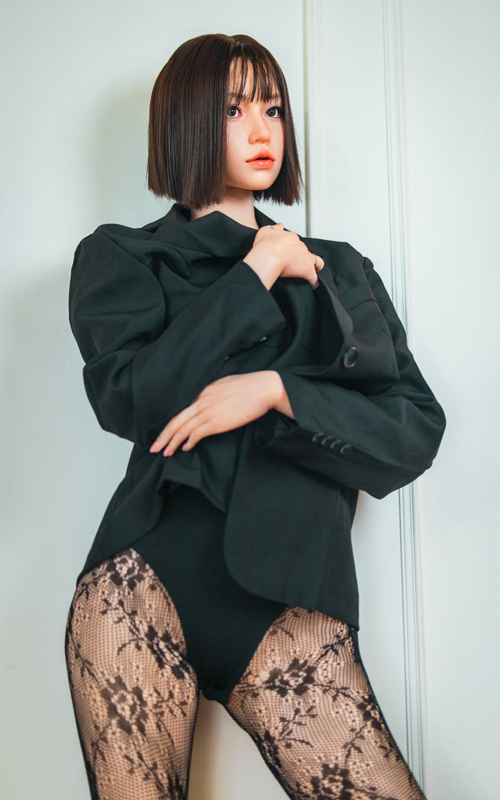 Zelex Doll K-Series 168 cm B Silicone - Arin full body rear view in black oversized blazer and lace patterned stockings, short dark bob hair, white studio background
