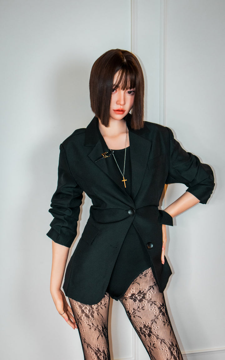 Zelex Doll K-Series 168 cm B Silicone - Arin full body standing pose in black oversized blazer and lace patterned stockings, short dark bob hair, white studio background
