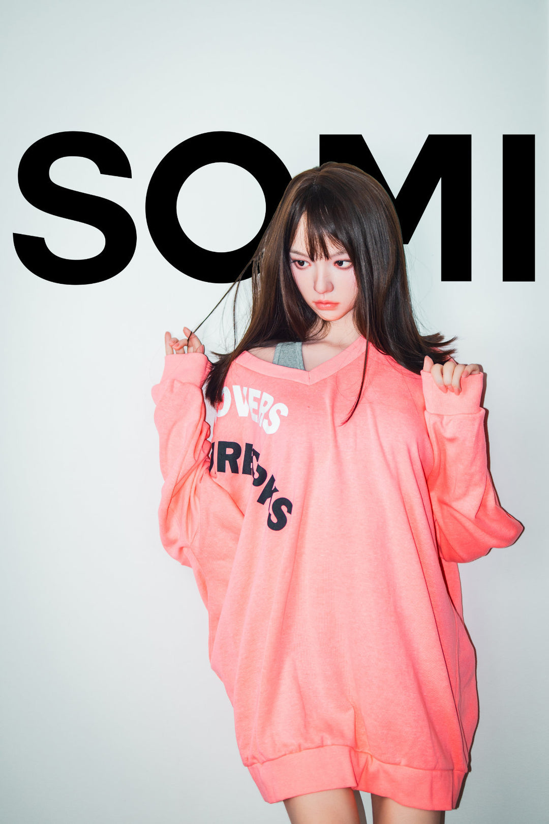 Zelex Doll K-Series 168 cm B Silicone - Somi full body front view in oversized pink hoodie with SOMI print, long dark brown hair, white studio background
