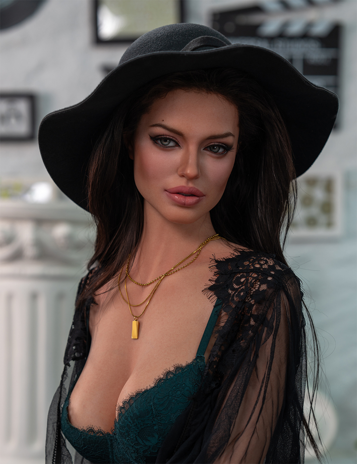 Sexdoll wearing a black hat and green dress with sheer overlay in an indoor setting
