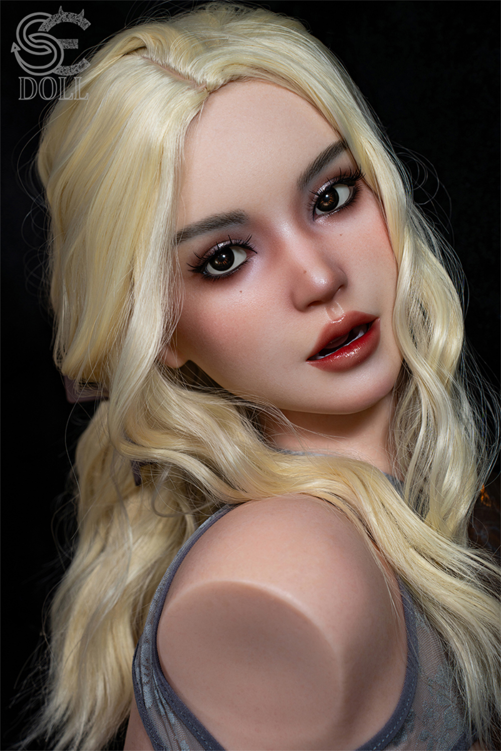 A high-detail facial close-up of the Isla Kane silicone head, highlighting realistic brown eyes, a slightly open mouth, and fair skin with soft makeup.