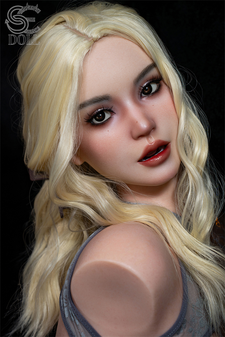 A high-detail facial close-up of the Isla Kane silicone head, highlighting realistic brown eyes, a slightly open mouth, and fair skin with soft makeup.